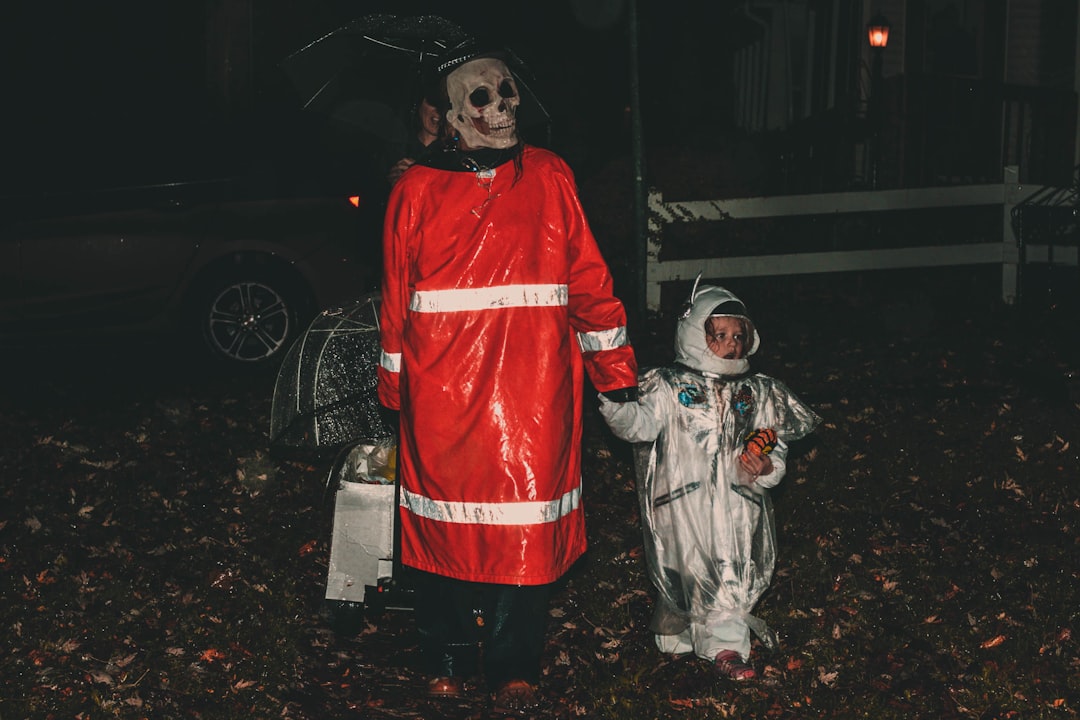 adult and child in Halloween costumes