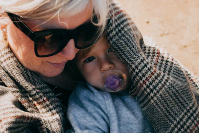 woman carrying baby wearing blue shirt