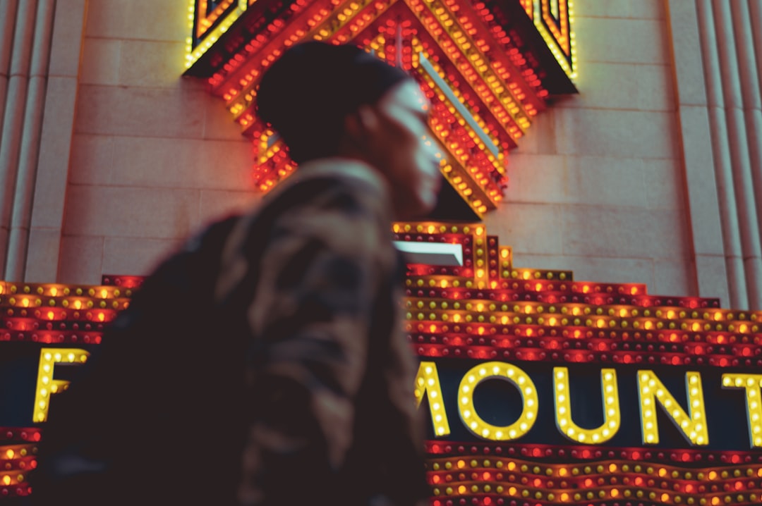 man standing beside building