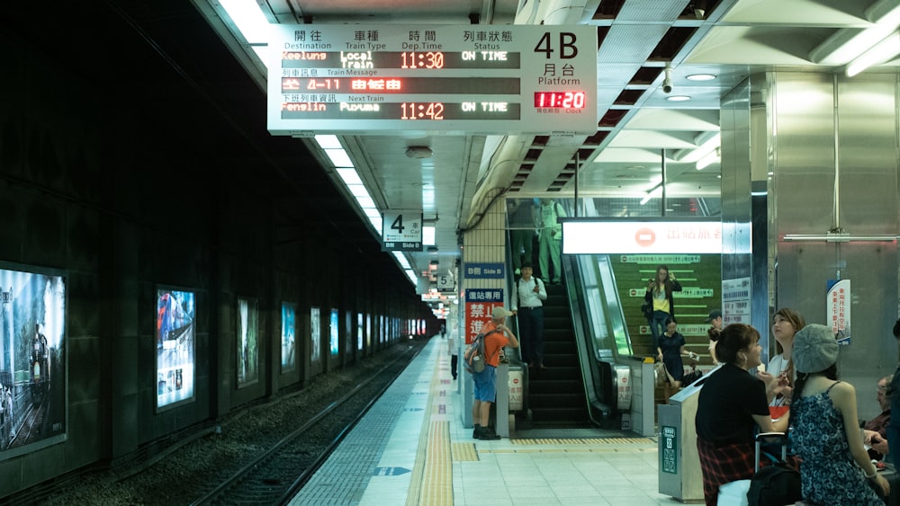 woman standing near the train railings