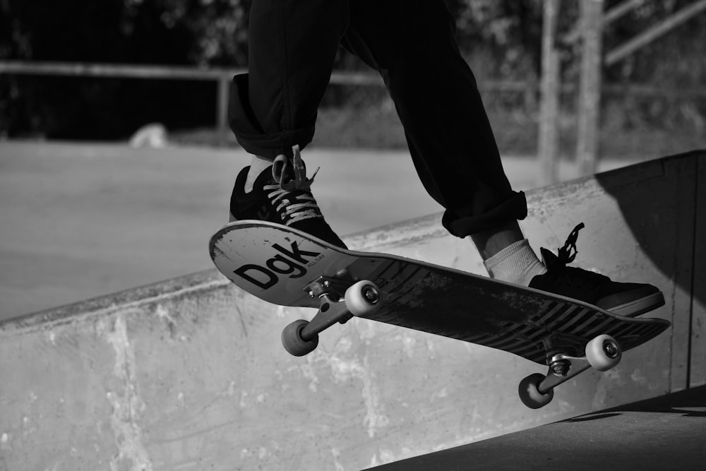 grayscale photography of person skating on mid air
