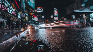 A dynamic digital billboard glowing at dusk on a busy urban street, capturing the attention of passersby.