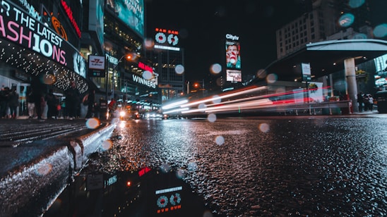 A dynamic digital billboard glowing at dusk on a busy urban street, capturing the attention of passersby.
