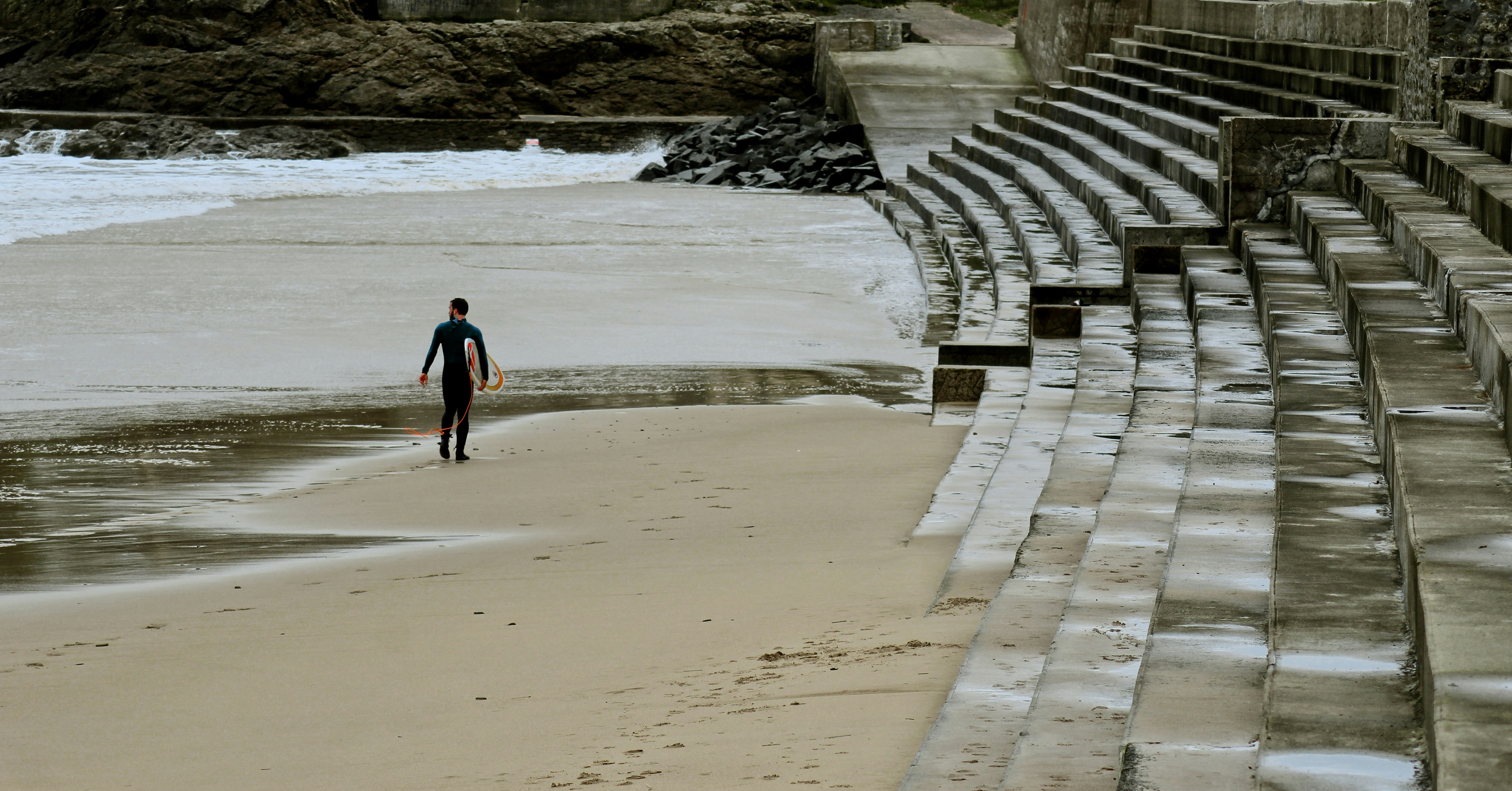 man standing on beach line