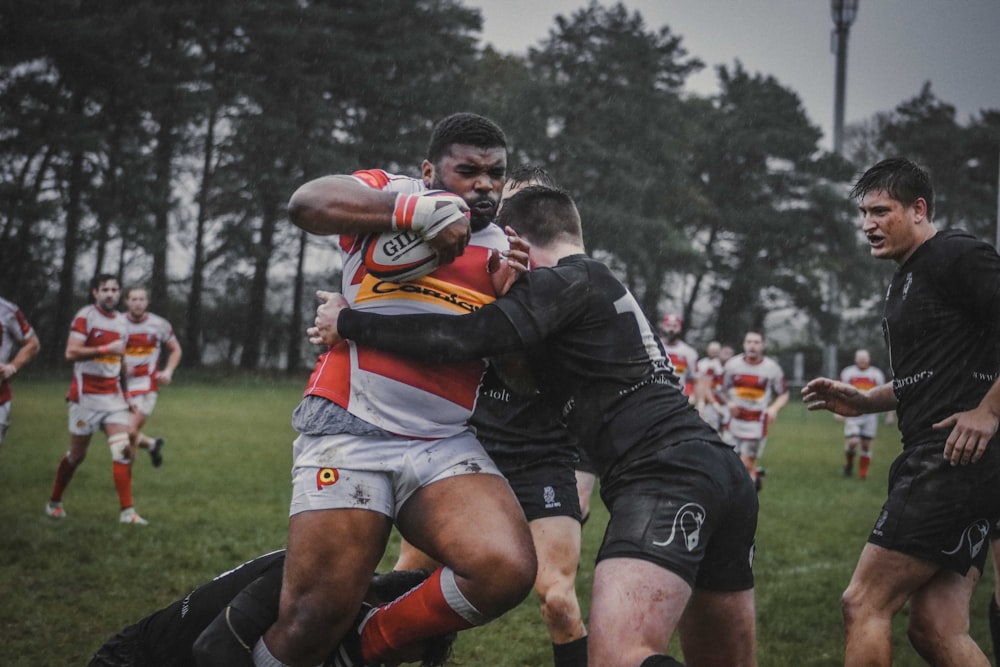 photography of men playing football during daytime