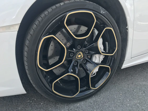 Close-up of a luxury car's air suspension system with sleek black and gold accents.