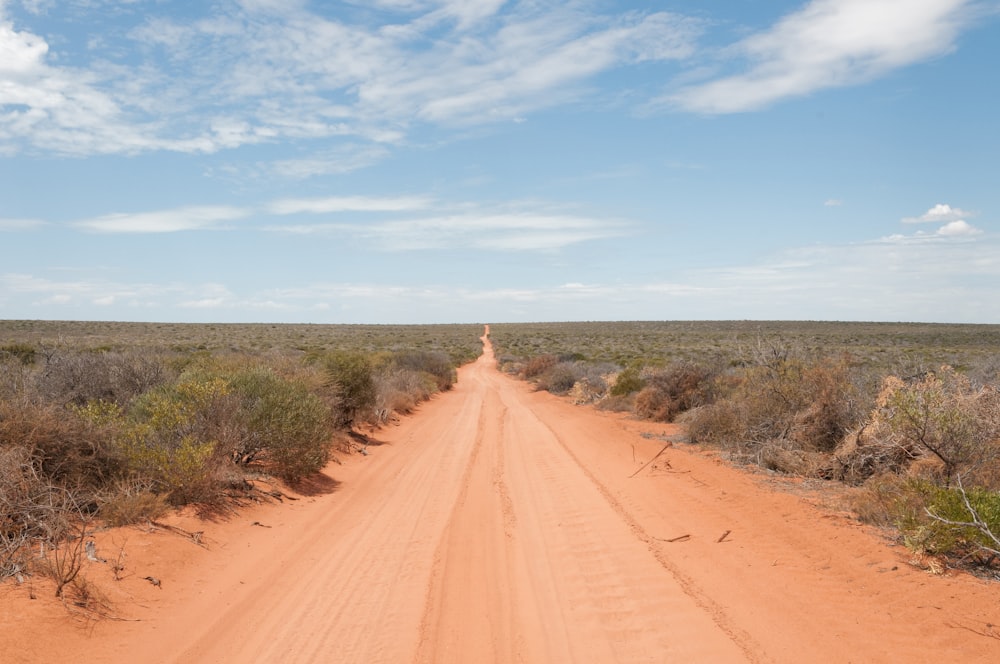 dirt road under blue sky