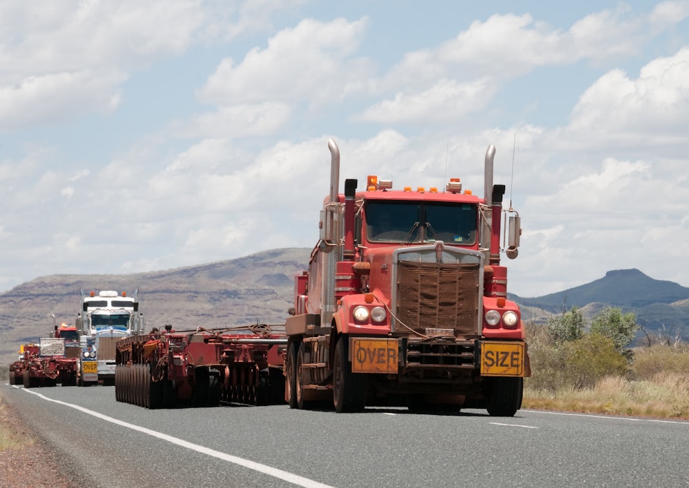 red and brown truck on paved road