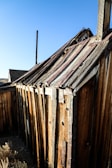 A rustic ag structure with heavy timber accents standing strong against a clear blue sky.