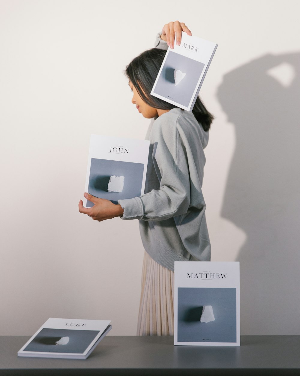 woman holding two John and mark books