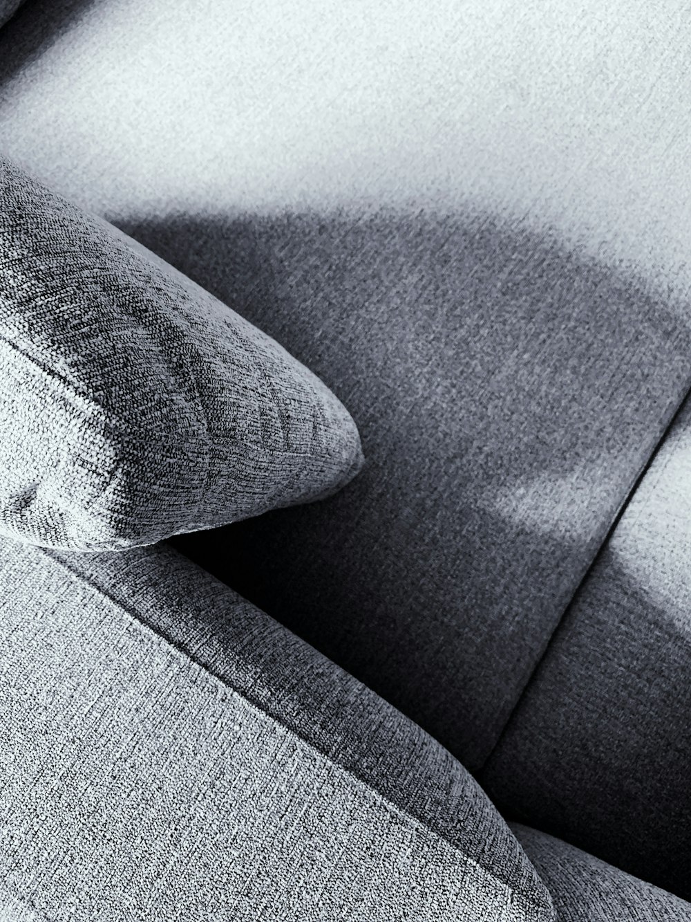 a close up of a couch with a pillow on it