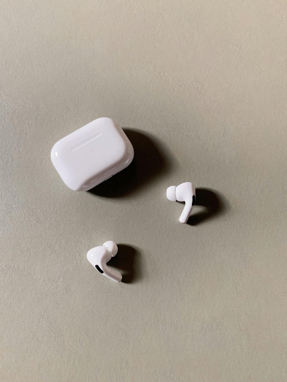 white wireless earbuds with charging case
