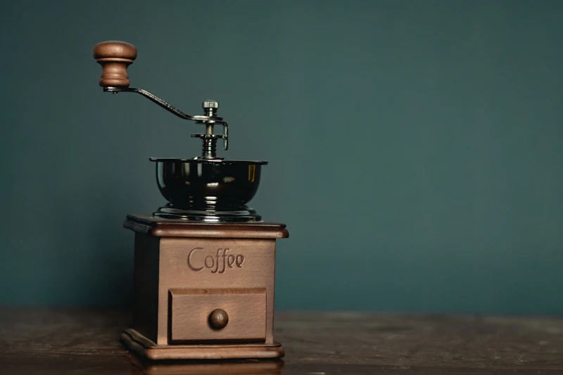 Wooden and steel manual coffee grinder, essential for a consistent grind