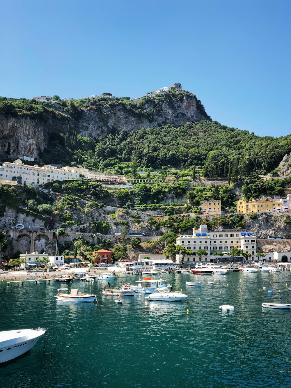 a group of boats floating on top of a body of water