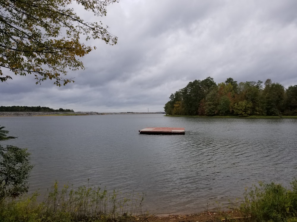 brown boat on body of water during daytime