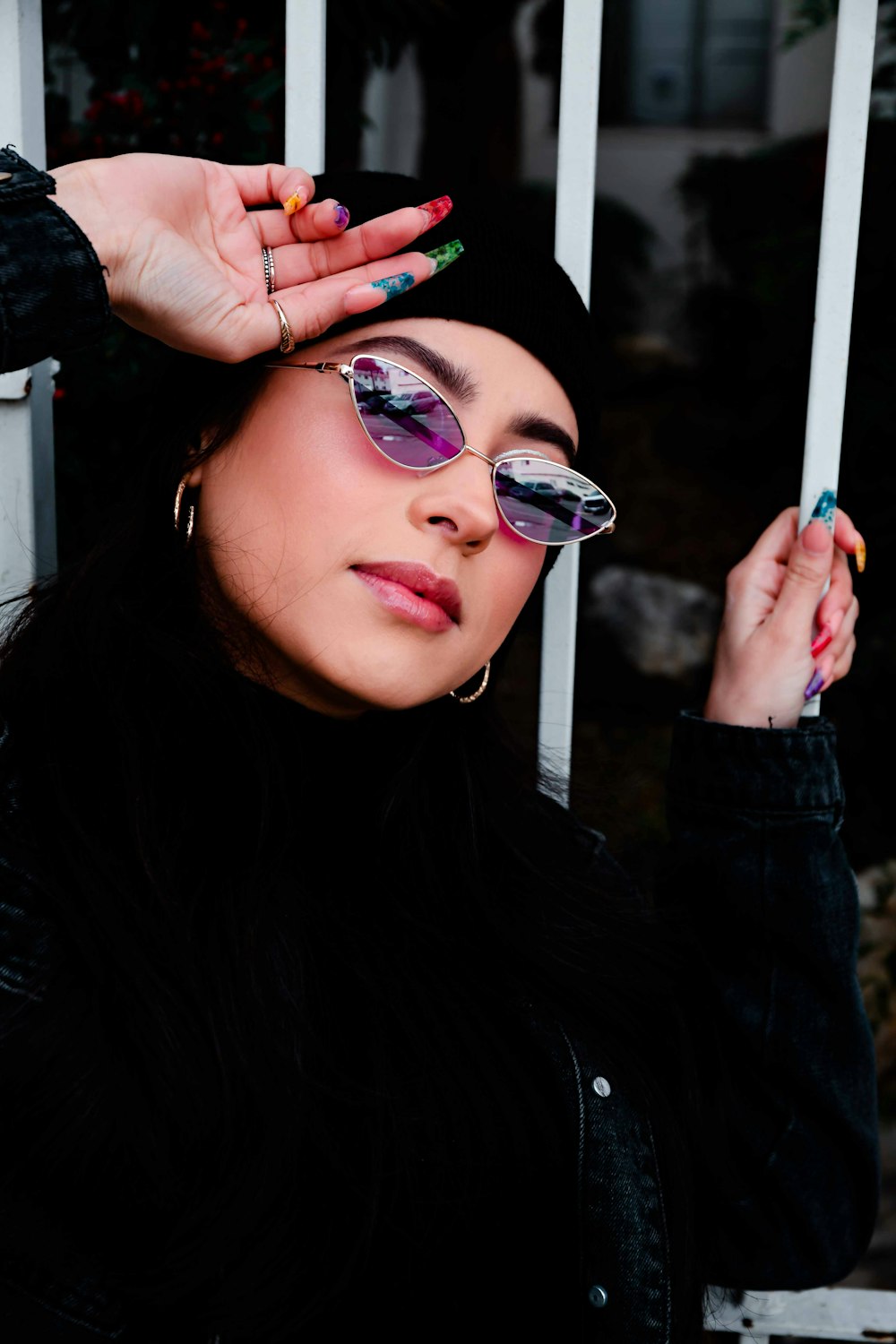 woman wearing black long-sleeved top and sunglasses taking selfie