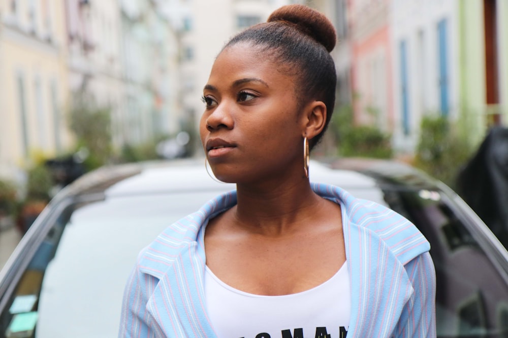 woman in front of vehicle looking to her left