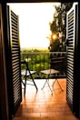 Private balcony with comfortable chairs overlooking the sunset.