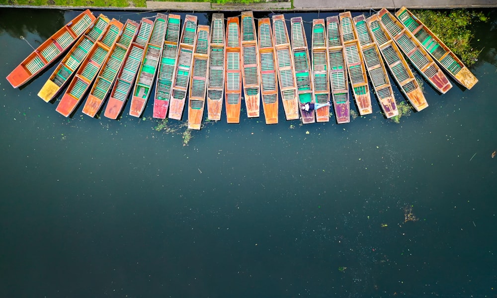 multicolored canoes on body of water during daytime