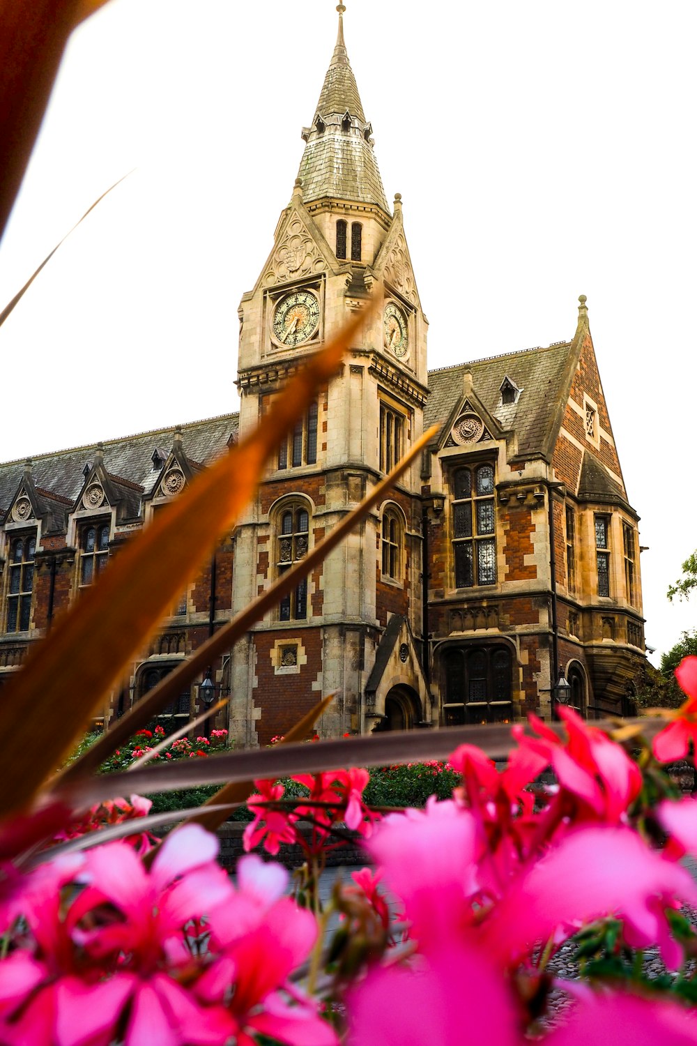 Pembroke College in Cambridge near flower garden during daytime