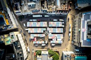 An aerial view of a busy market in an Indian city, highlighting economic activity.