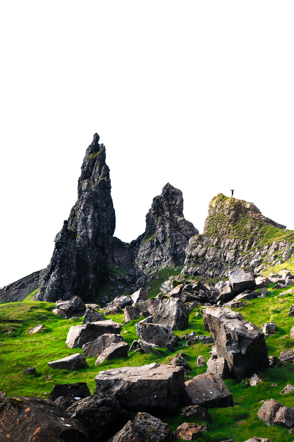 gray rock formations on green field during daytime