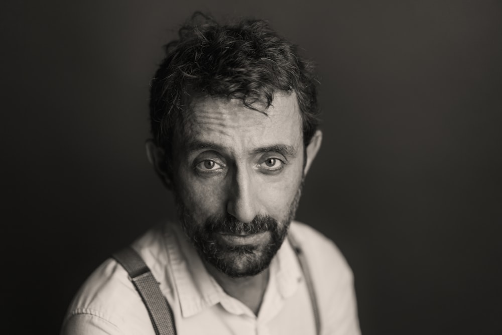 a black and white photo of a man with suspenders