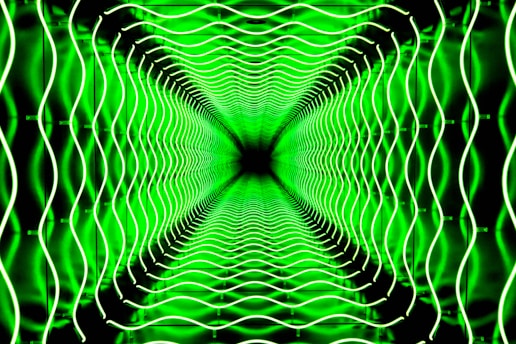 An abstract scene features a symmetrical pattern of wavy neon green lines that create a tunnel effect, invoking a sense of depth and infinity.