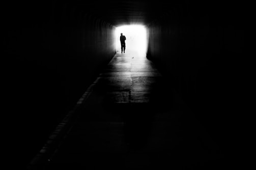A dark tunnel with a bright light at the end, representing breakthrough and hope.