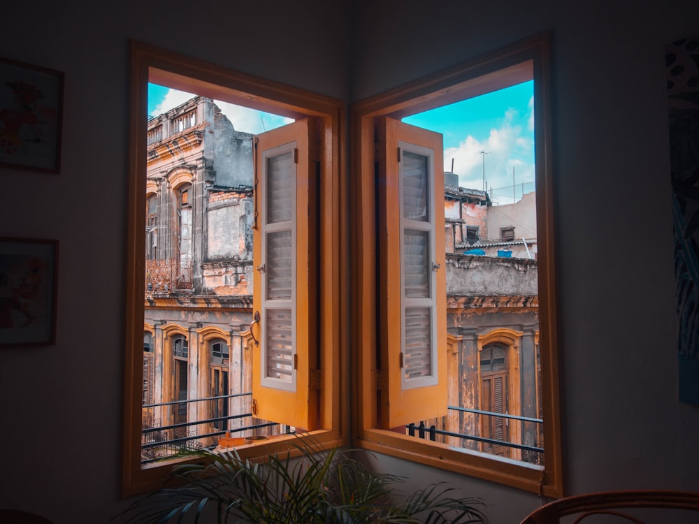 a couple of windows with a view of a city