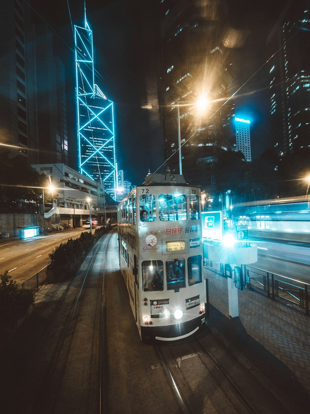 white double-decked bus at night