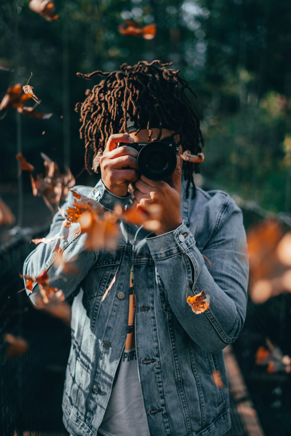 selective focus photography of woman holding black camera