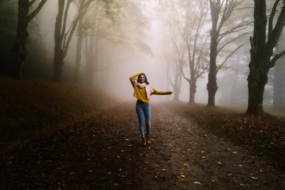 woman walking near trees during day