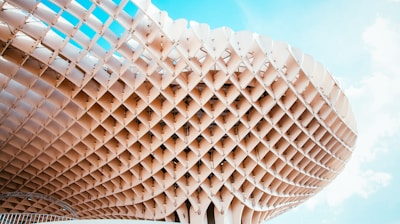 beige building under blue cloudy sky