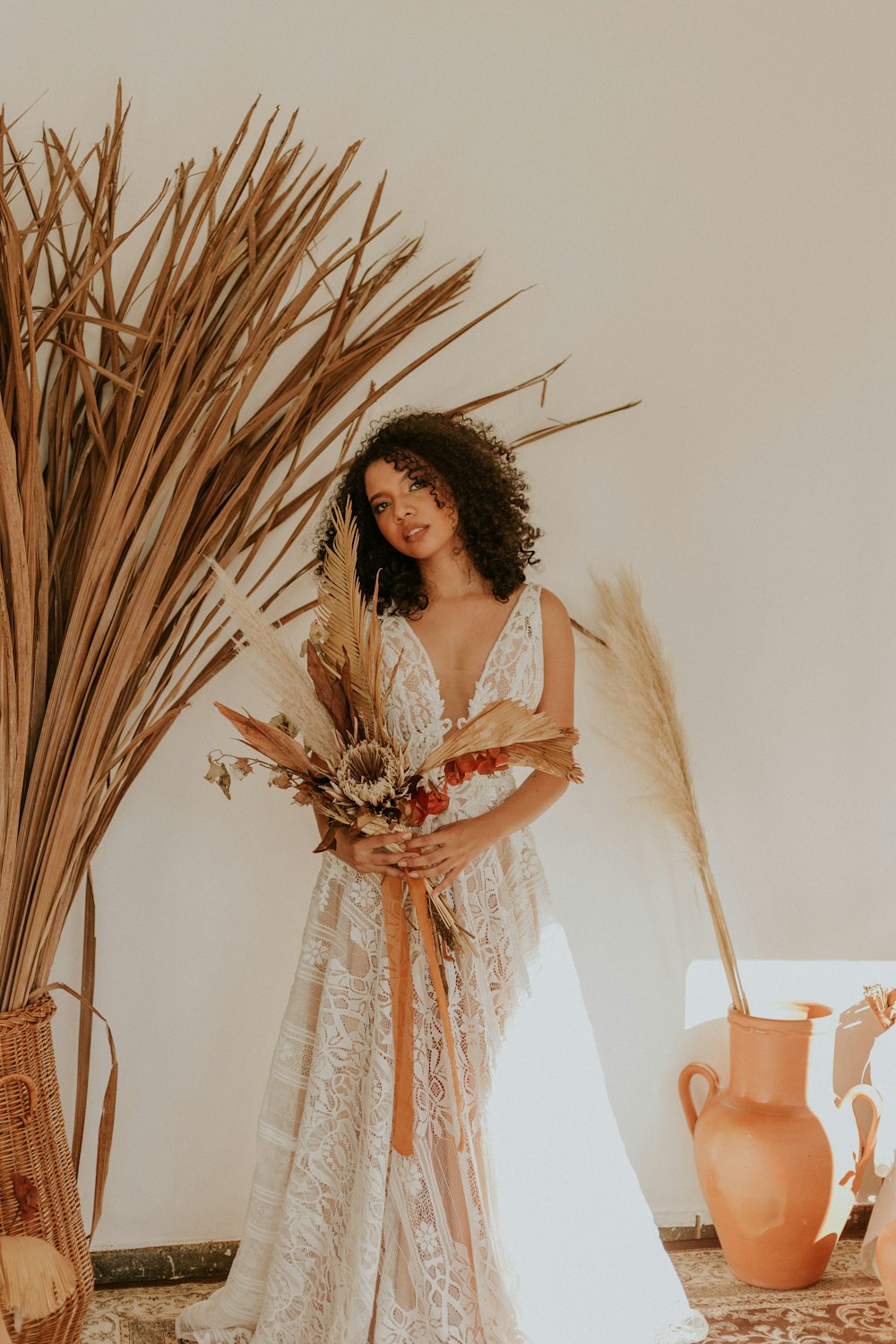 woman wearing floral lace dress and bouquet