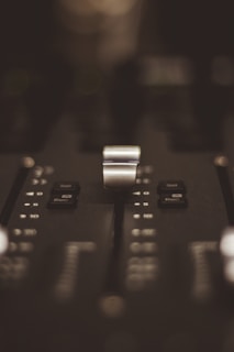 A close-up of a mixing console during post-production, highlighting sound editing work.