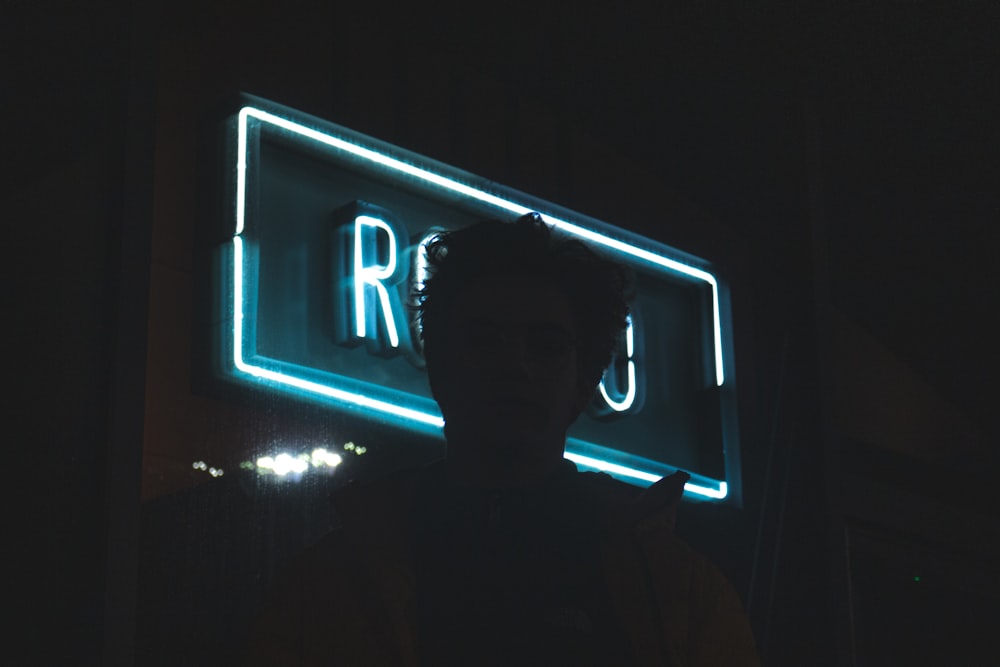 man standing beside store