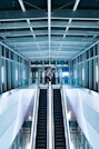 person in black shirt standing beside escalator