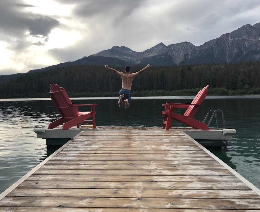 man jumping off dock