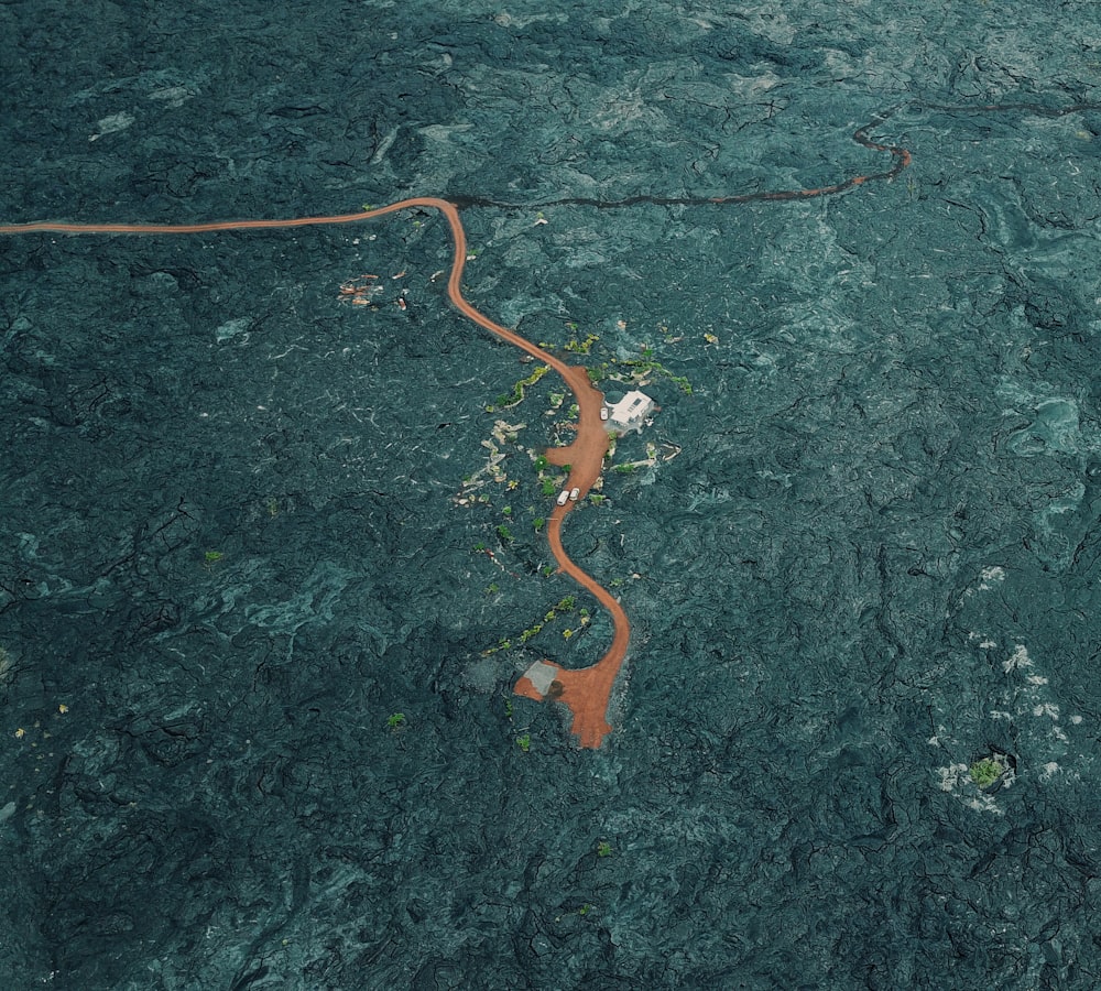 an aerial view of a river running through a forest