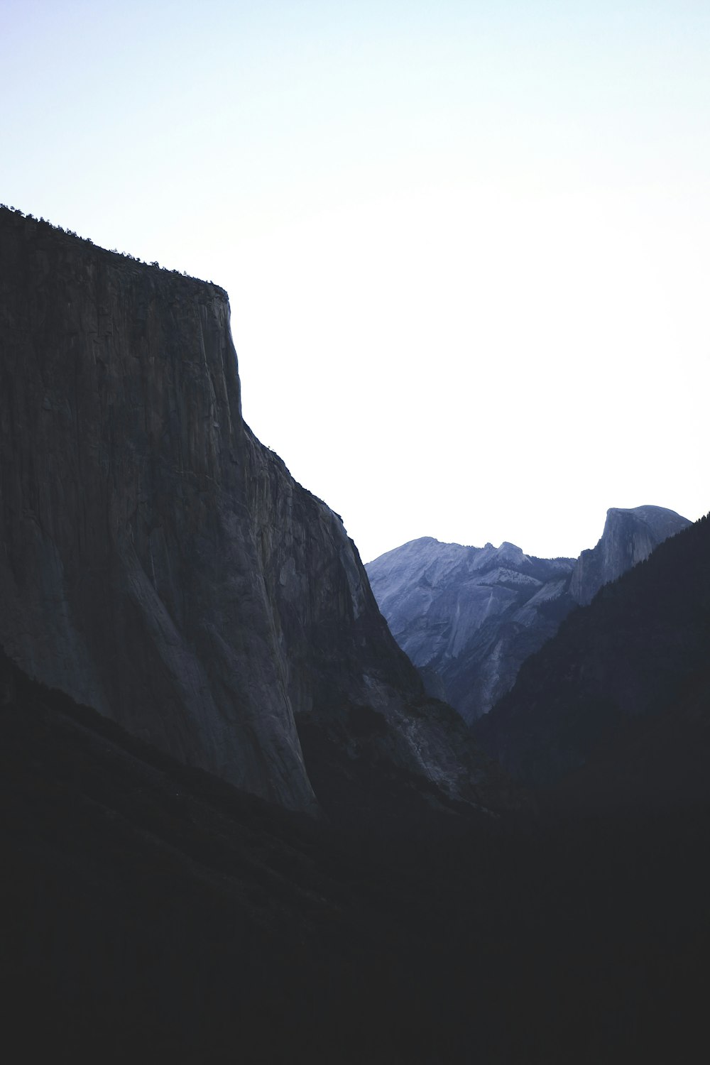 silhouette of mountain under white sky