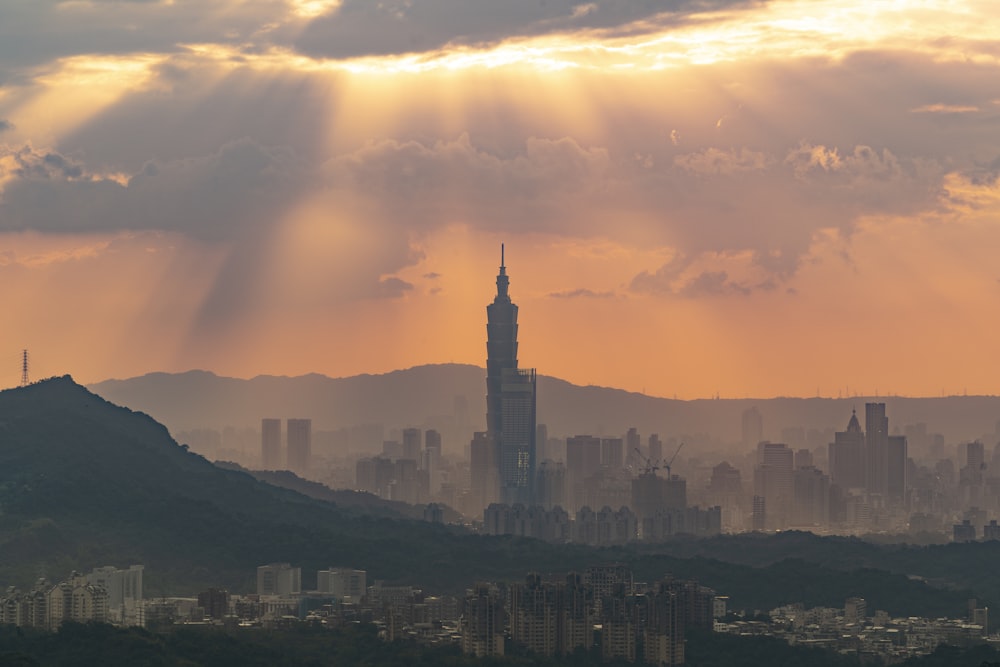 a view of a city from a hill at sunset