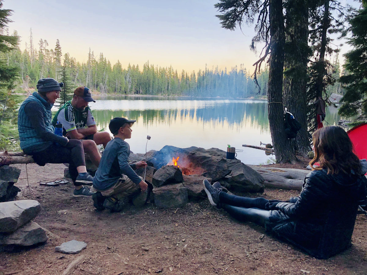 People camping beside a mountain lake