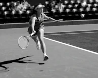 A thrilling moment from a tennis match with players reaching for the ball.