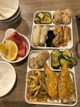 Delicious crispy katsu bento served with rice and fresh vegetables on a rustic wooden table