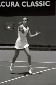 An action photo of a player swinging a Starinova racket during an intense match.