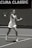 A tennis player wearing a white outfit is captured mid-action on a tennis court, preparing to hit a ball with a forehand stroke. The background shows a banner with the text 'Acura Classic.' The image is in black and white, highlighting the player's focus and motion.