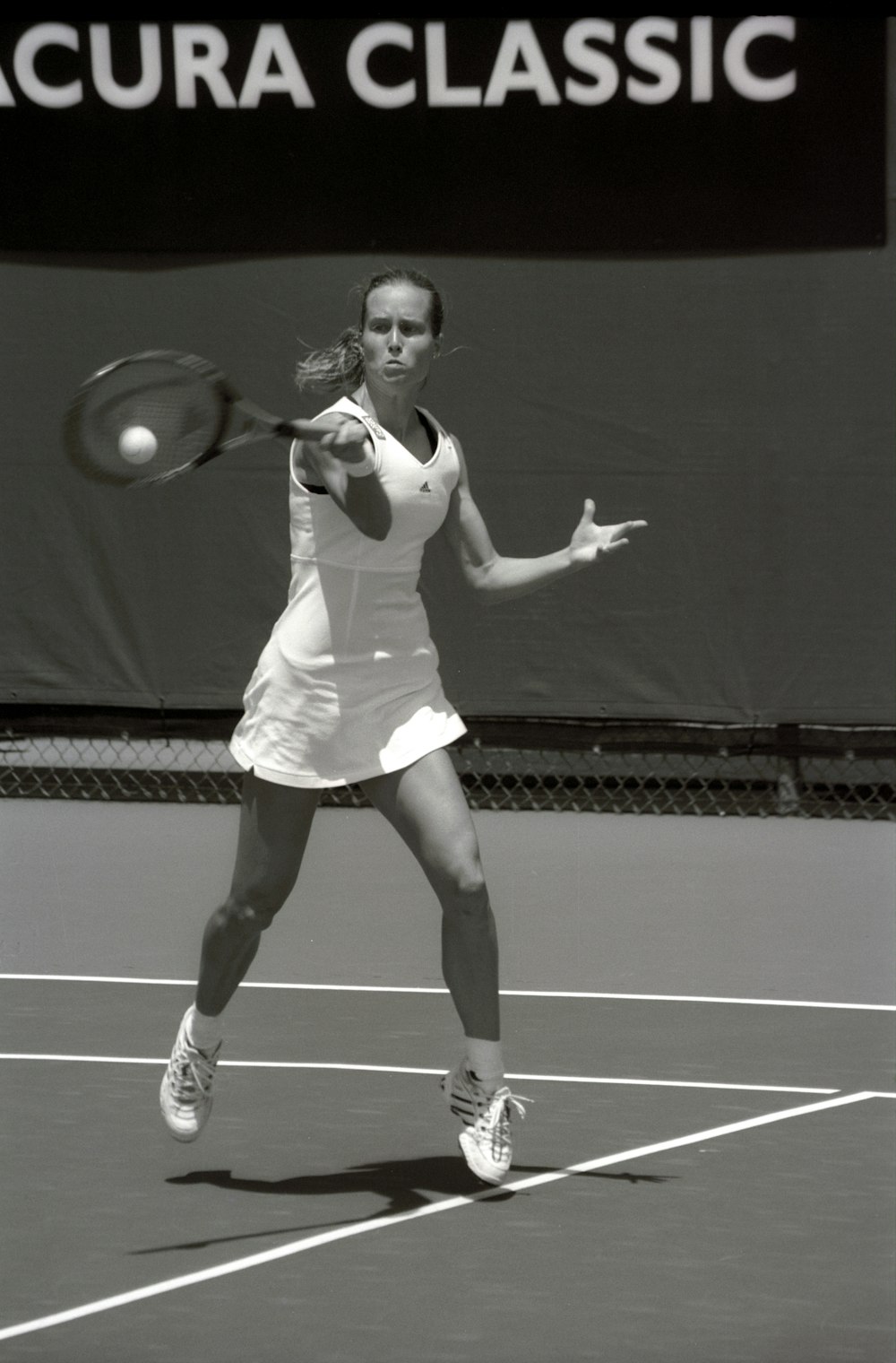 grayscale photography of woman playing tennis