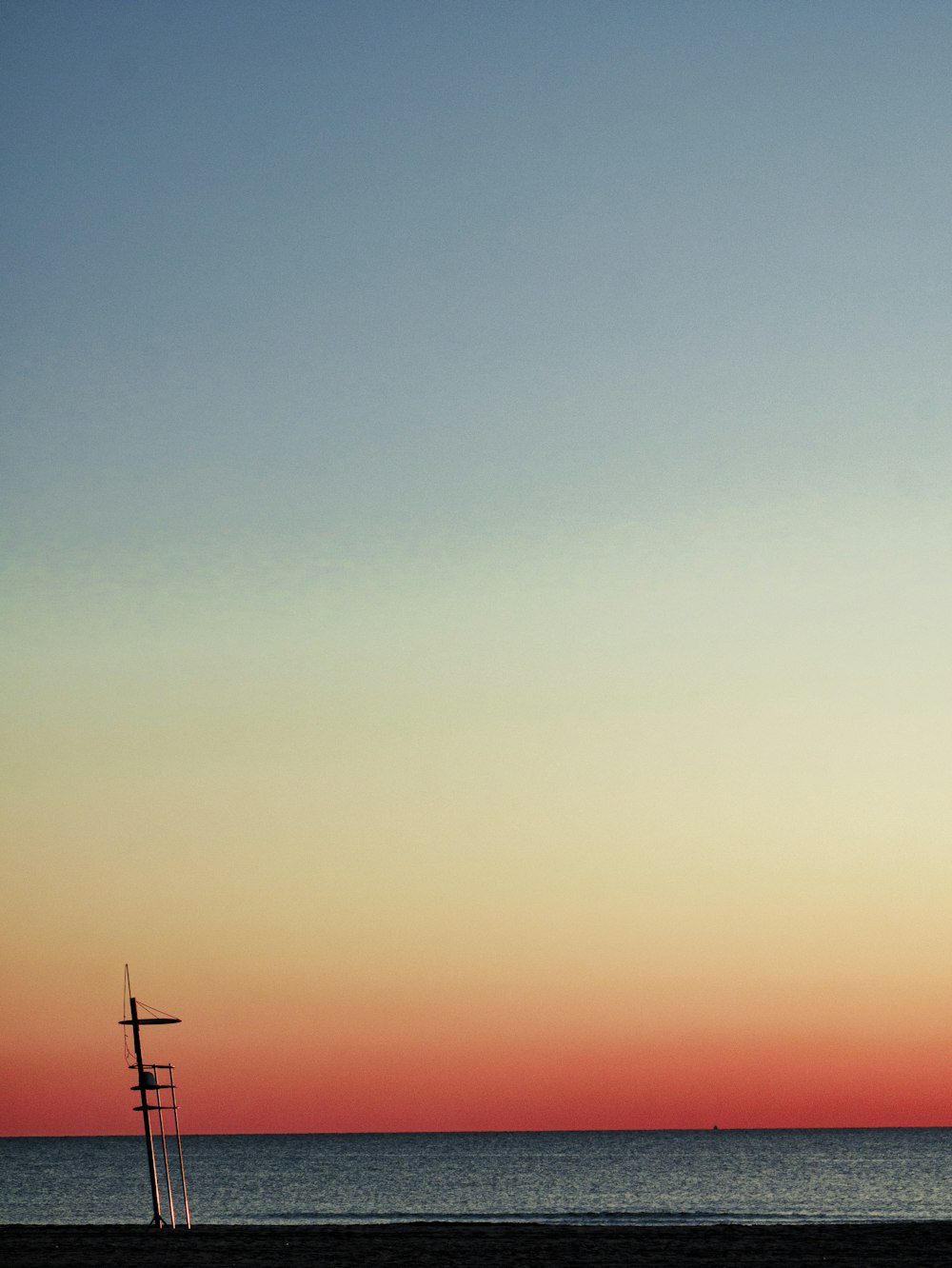 a plane flying over the ocean at sunset