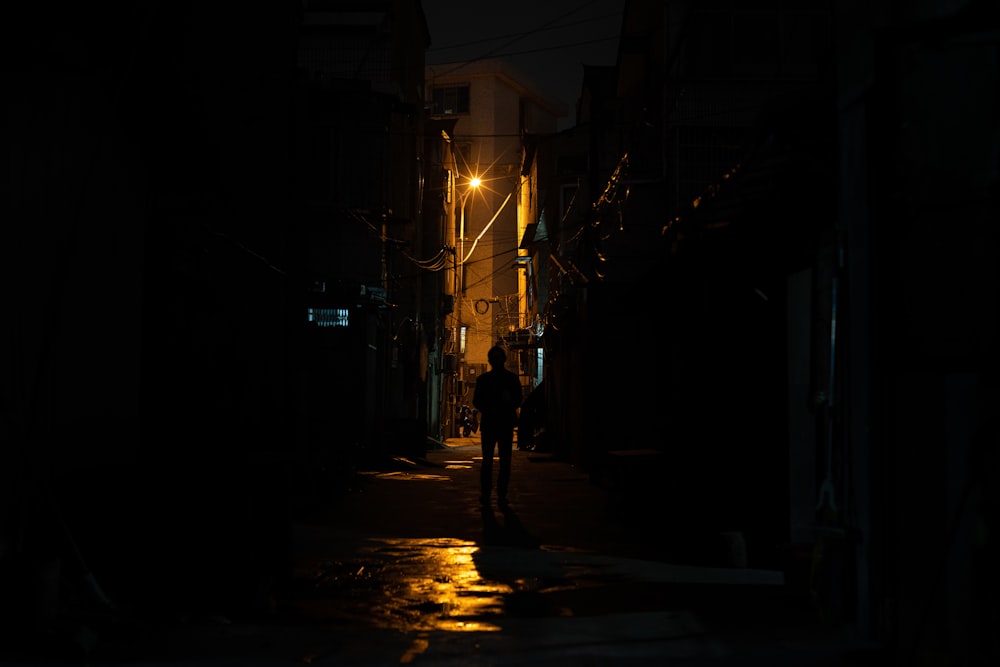 silhouette of person near buildings